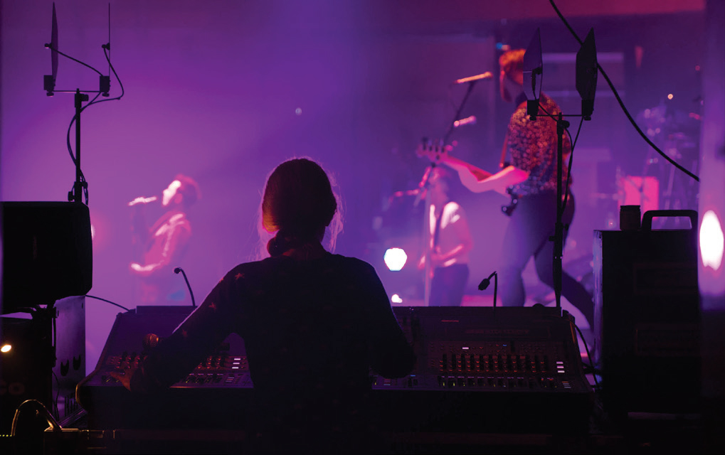 Escenario Musical a la Izquierda: Concierto en Vivo con luces y sonido de alta calidad